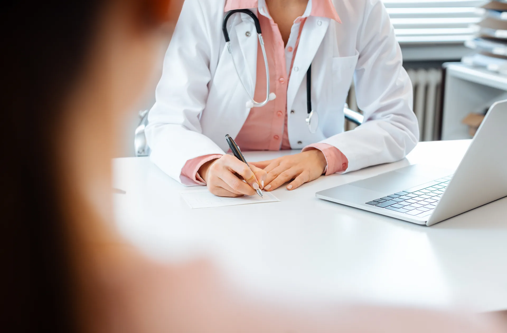 A breast specialists consults with a patient to explain the factors that influence the cost of breast lump removal surgery in Singapore.